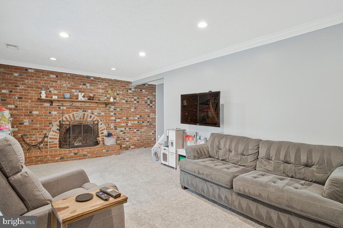437 Kingwood Road Linthicum Heights, MD 21090 - Photo 27 of 38 a living room with furniture and a fireplace