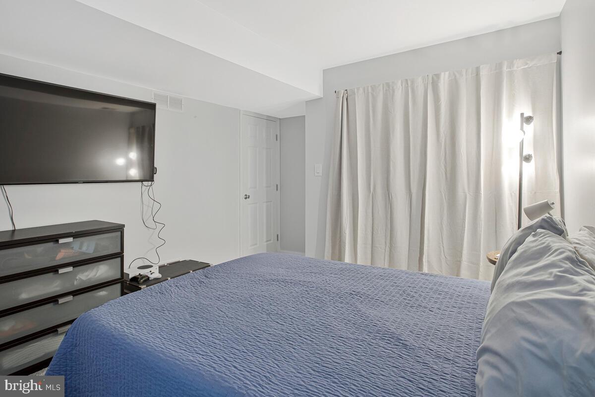 437 Kingwood Road Linthicum Heights, MD 21090 - Photo 29 of 38 a bedroom with a bed and a flat screen tv
