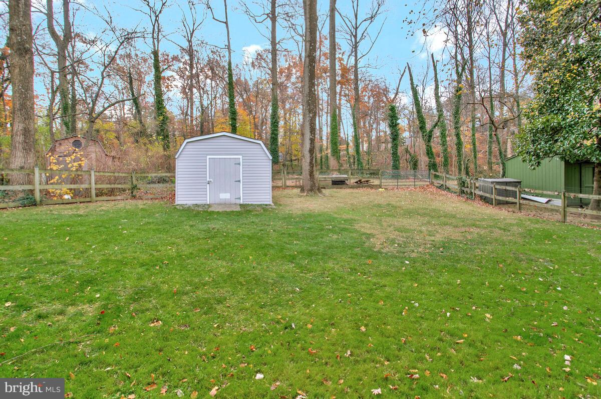 437 Kingwood Road Linthicum Heights, MD 21090 - Photo 34 of 38 a view of a tiny house with a big yard and large trees