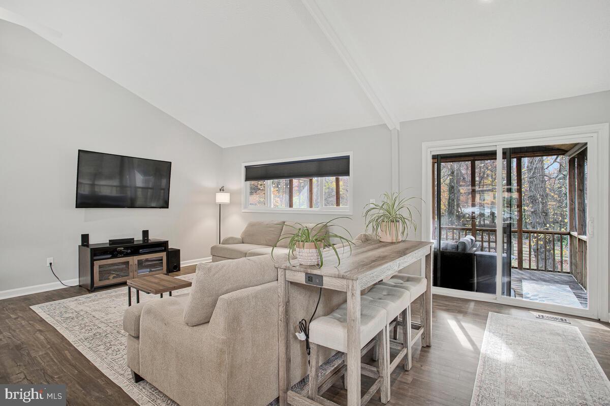 437 Kingwood Road Linthicum Heights, MD 21090 - Photo 7 of 38 a living room with furniture a flat screen tv and a floor to ceiling window