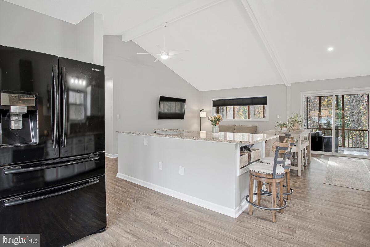 437 Kingwood Road Linthicum Heights, MD 21090 - Photo 8 of 38 a kitchen with a refrigerator and chairs