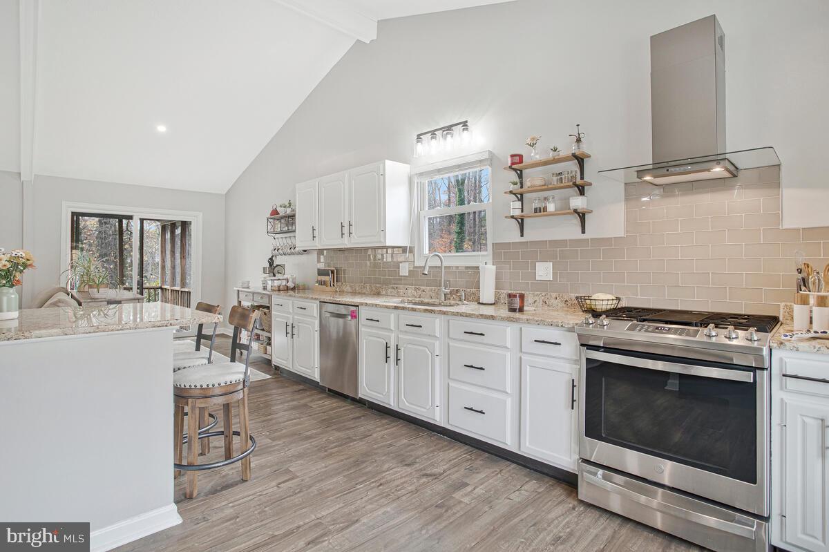 437 Kingwood Road Linthicum Heights, MD 21090 - Photo 9 of 38 a kitchen with a stove a sink and a refrigerator