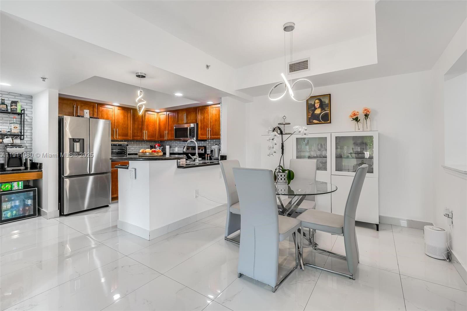 100 North Federal Highway, Unit 1413 Fort Lauderdale, FL 33301 - Photo 2 of 33 a kitchen with stainless steel appliances a refrigerator a stove a sink dishwasher with a dining table and chairs