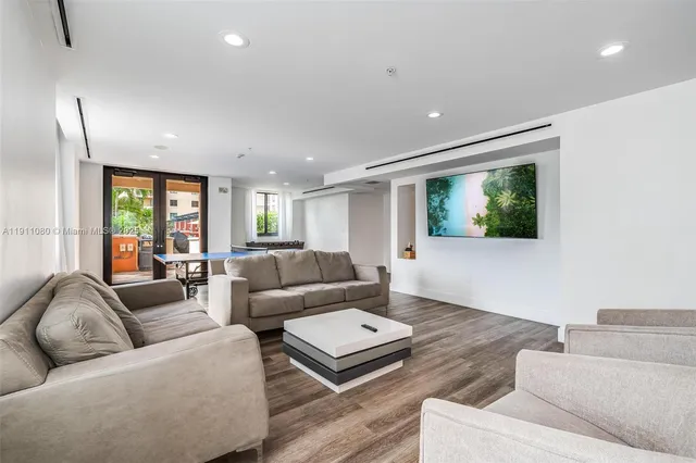 a room with furniture pool table and flat screen tv