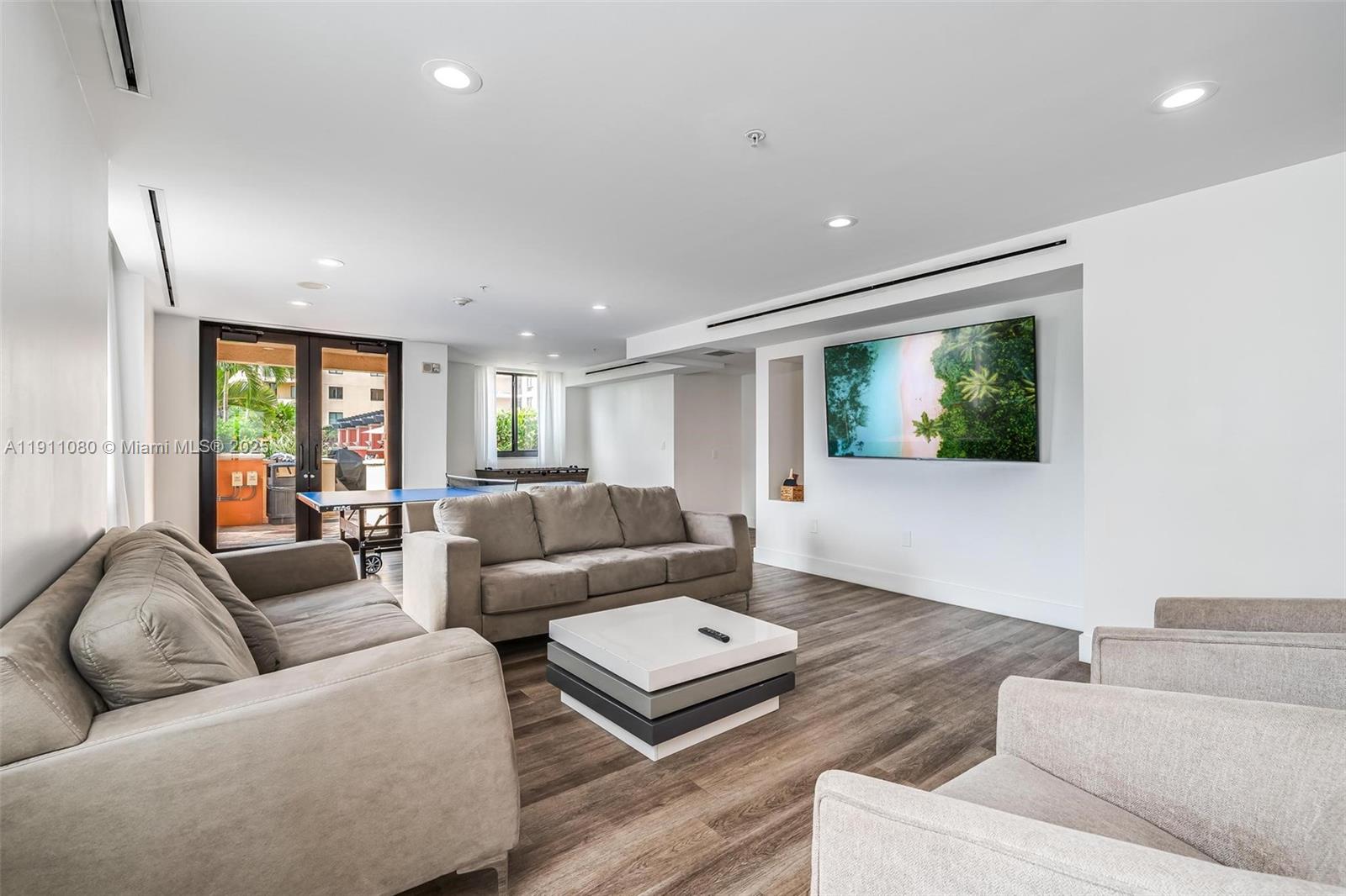 100 North Federal Highway, Unit 1413 Fort Lauderdale, FL 33301 - Photo 25 of 33 a living room with furniture and a flat screen tv