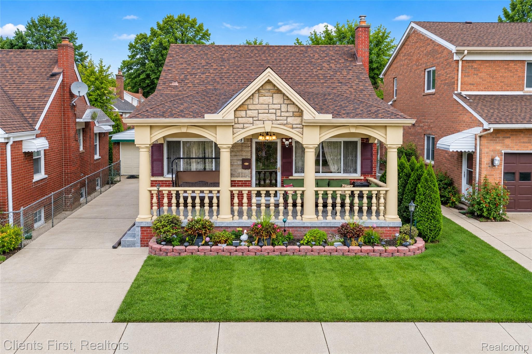 5430 Chase Road Dearborn, MI 48126 - Photo 25 of 34 Stone facade with a covered porch, brick base, and decorative porch balusters