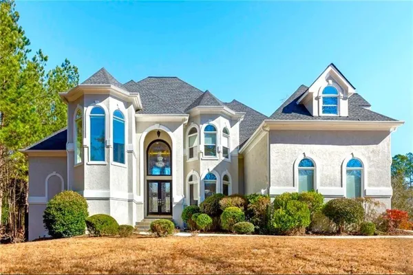 a front view of a house with a yard