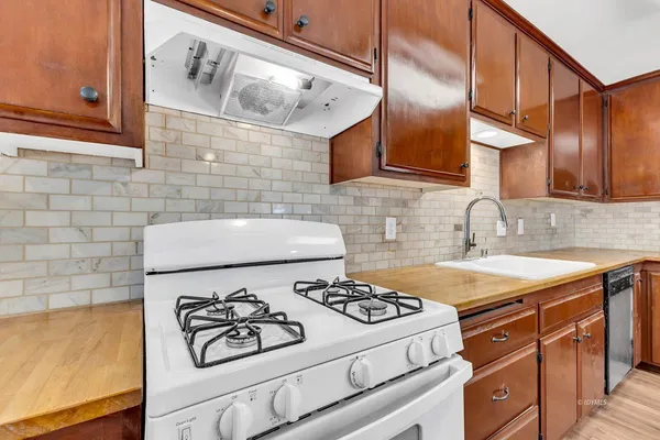 a kitchen with a stove and a refrigerator
