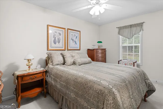 a bedroom with bed and window