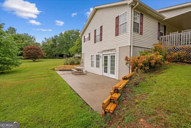 a backyard of a house with table and chairs