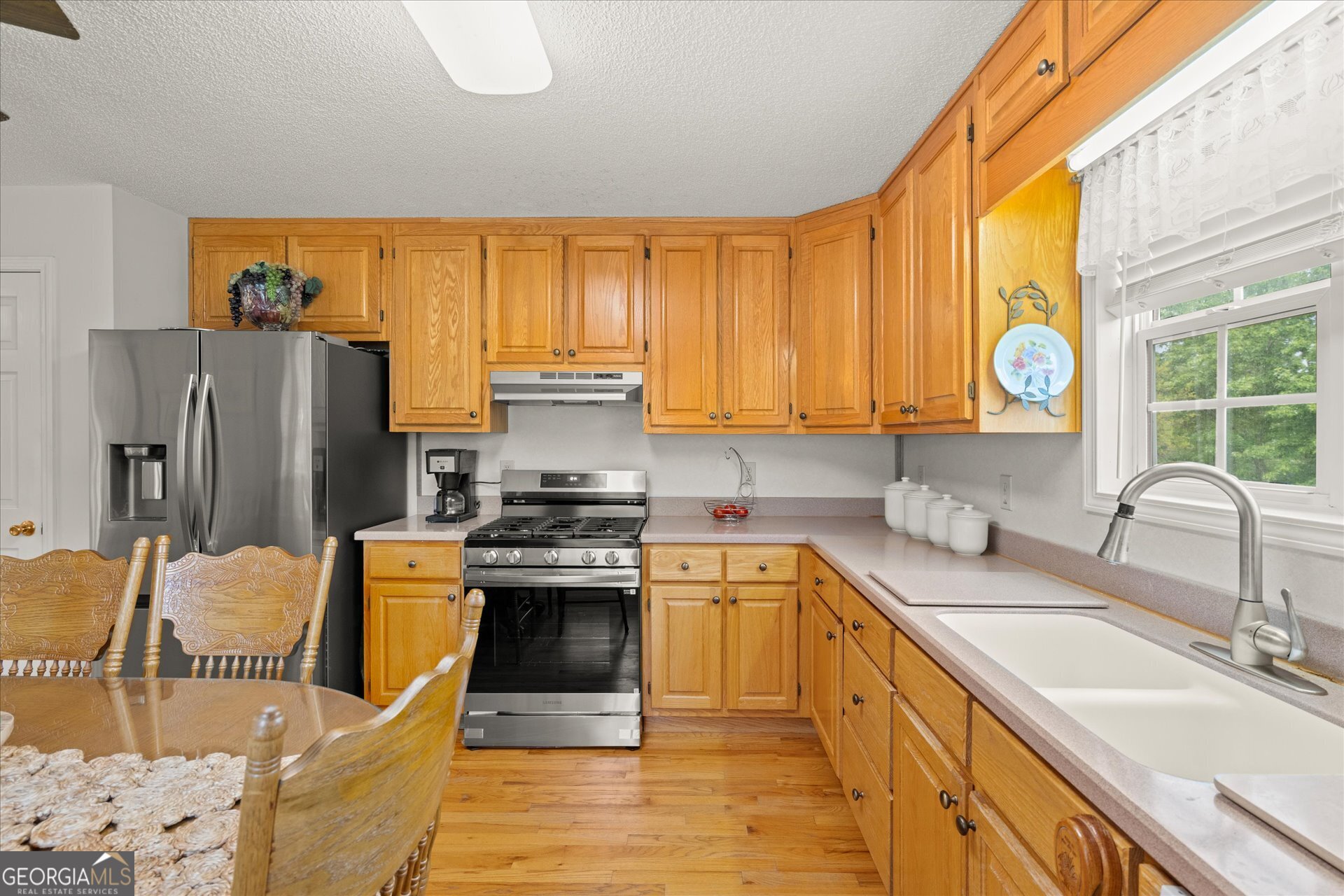 2643 Macedonia Road Franklin, GA 30217 - Photo 4 of 47 a kitchen with stainless steel appliances granite countertop a sink stove and refrigerator