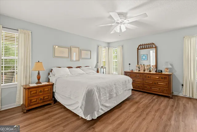 a bed room with a bed and a ceiling fan