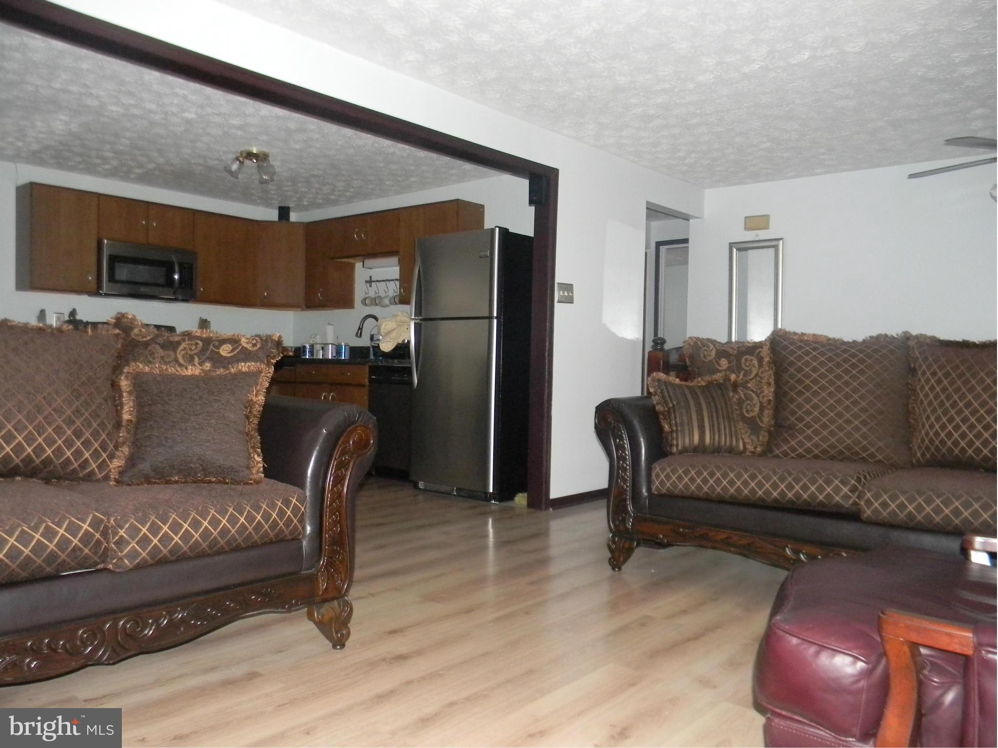3102 Northmont Road Baltimore, MD 21244 - Photo 8 of 25 a living room with furniture and a flat screen tv