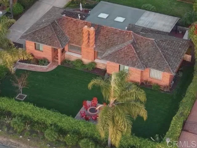 a backyard of a house with lots of green space and fountain