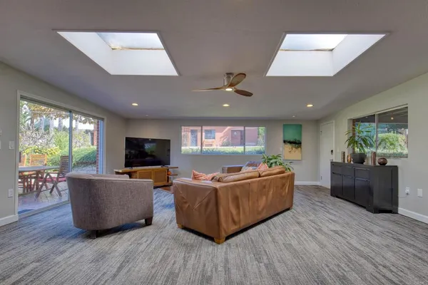 a living room with furniture and wooden floor