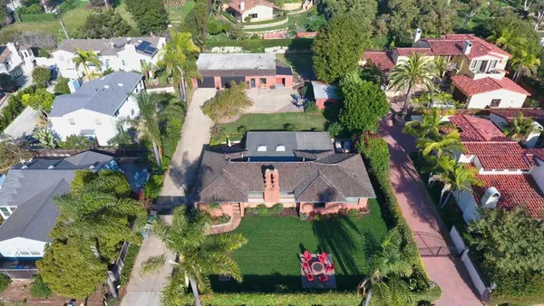 an aerial view of multiple houses with yard