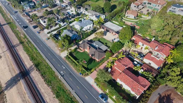 an aerial view of residential houses with outdoor space