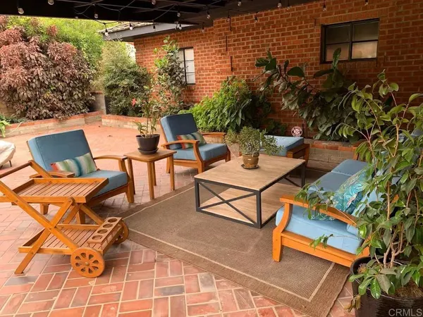 a view of a patio with table and chairs and potted plants