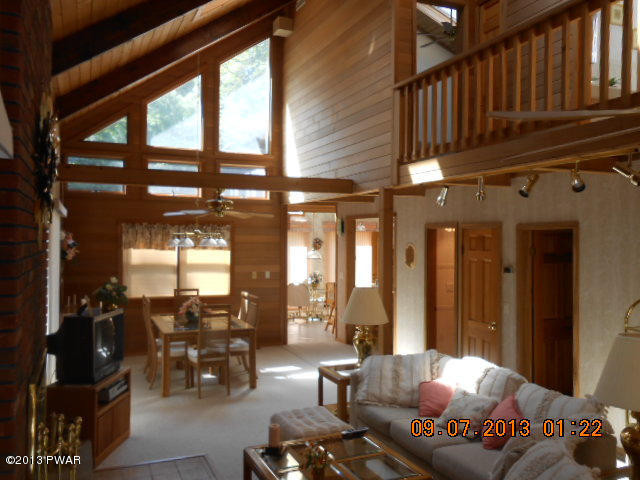 144 Raccoon Court Bushkill, PA 18324 - Photo 22 of 29 a living room with furniture and floor to ceiling windows