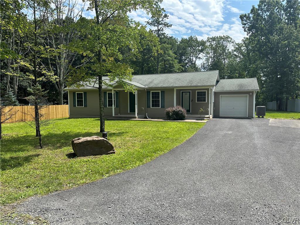 a front view of house with yard and green space