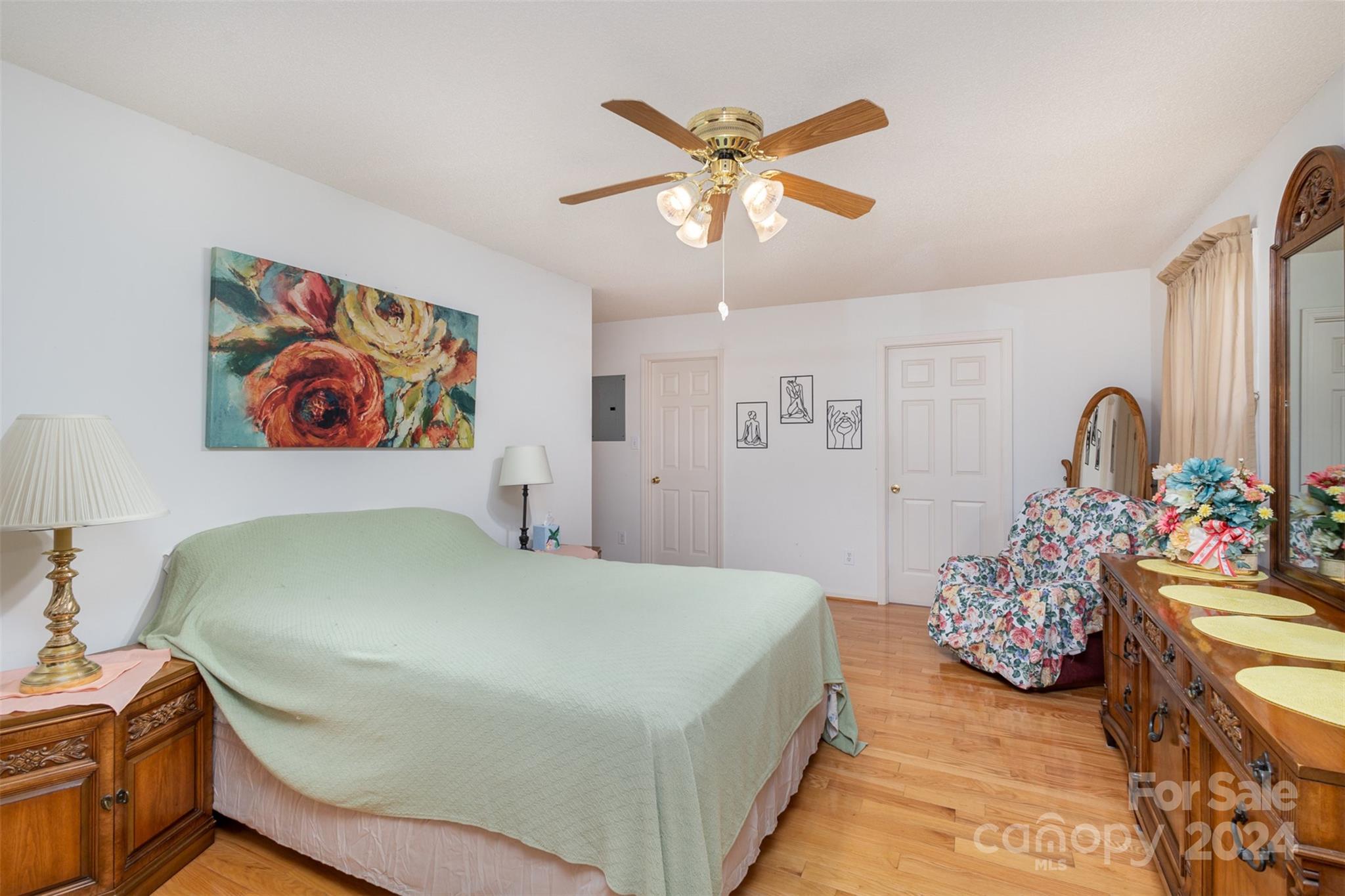 5306 Macedonia Church Road Vale, NC 28168 - Photo 17 of 35 a bedroom with a bed and a chandelier