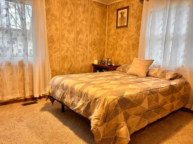 a bedroom with a bed and a window