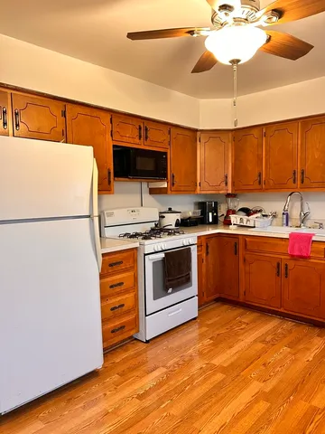 a kitchen with stainless steel appliances a stove a sink and a refrigerator