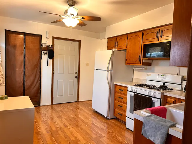 a kitchen with stainless steel appliances a stove a refrigerator and a microwave