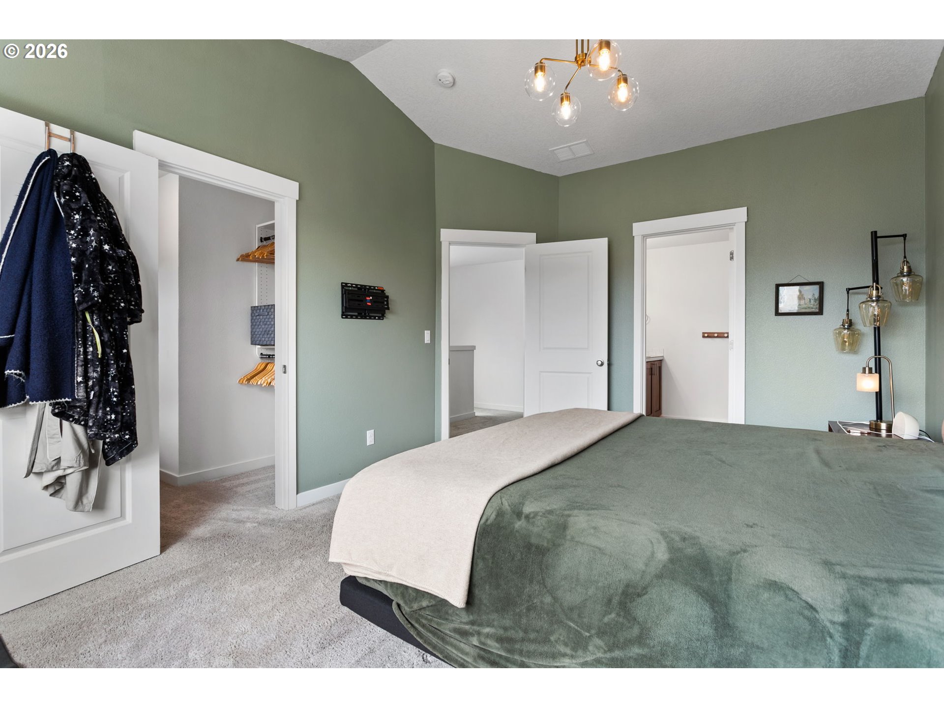 808 South 23rd Avenue Cornelius, OR 97113 - Photo 16 of 36 a bedroom with a large bed and a chandelier