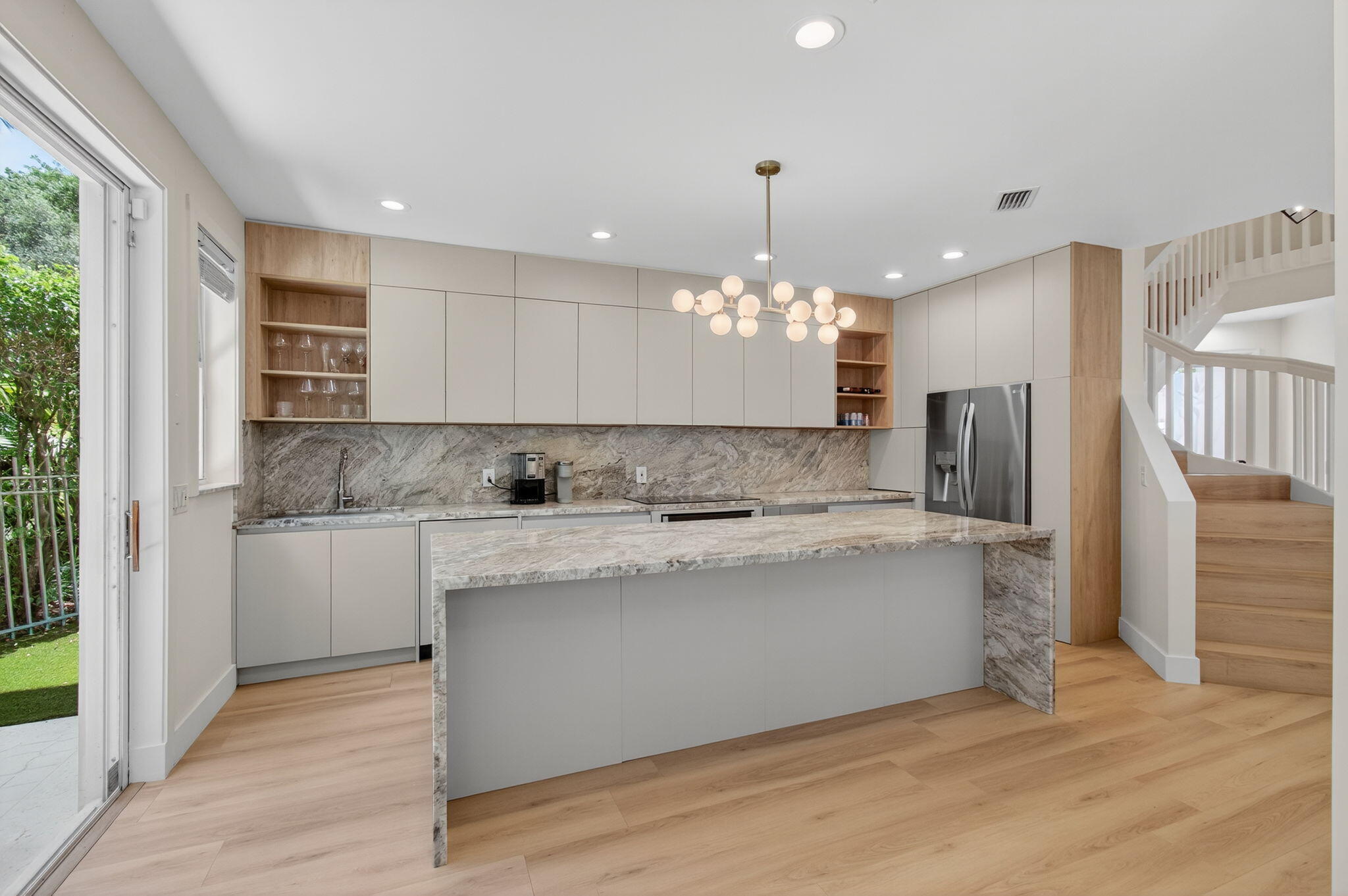 2621 Northwest 53rd Drive Boca Raton, FL 33496 - Photo 11 of 52 a large kitchen with kitchen island a sink stainless steel appliances and cabinets