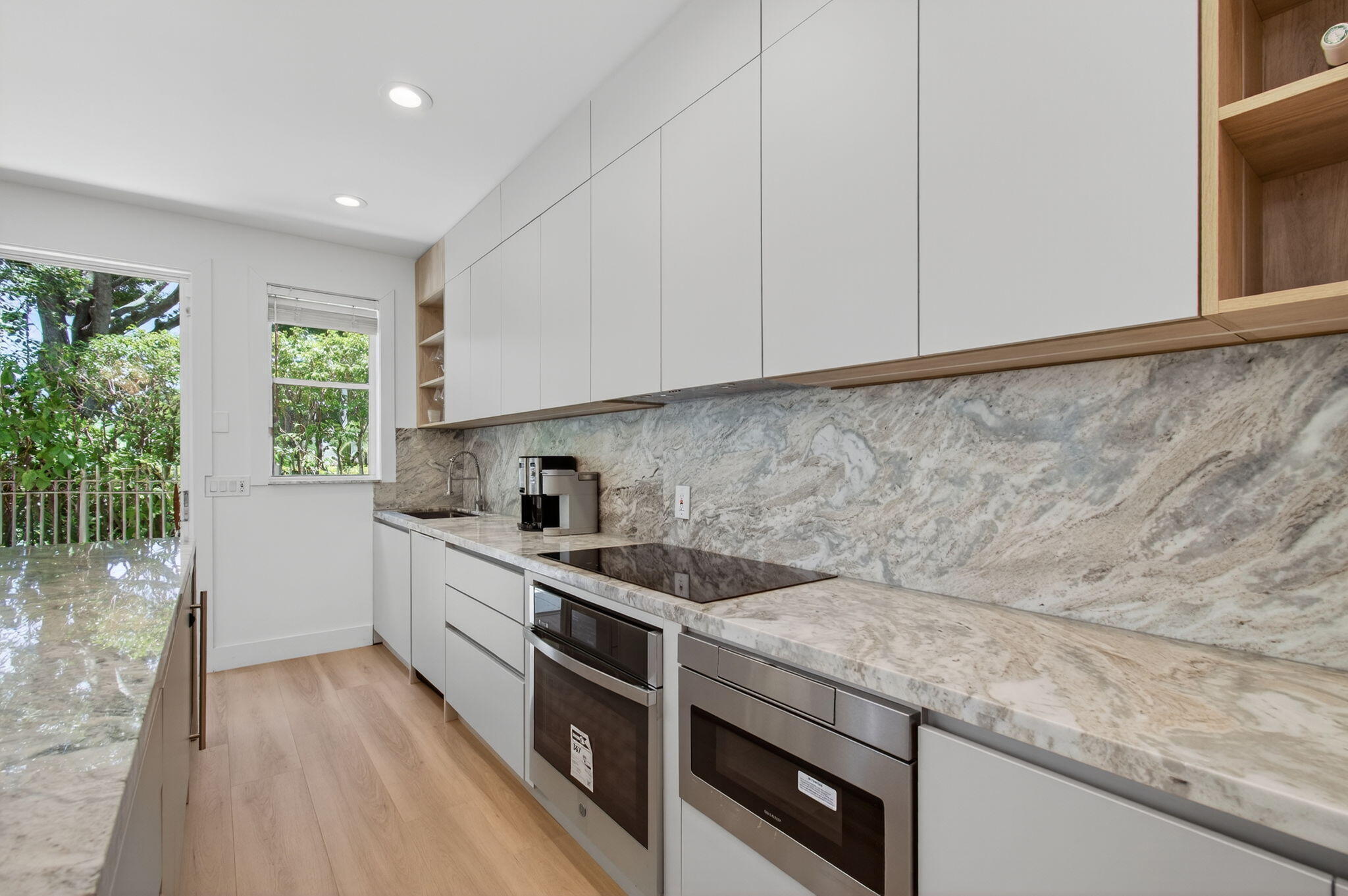 2621 Northwest 53rd Drive Boca Raton, FL 33496 - Photo 13 of 52 a kitchen that has a sink and a stove