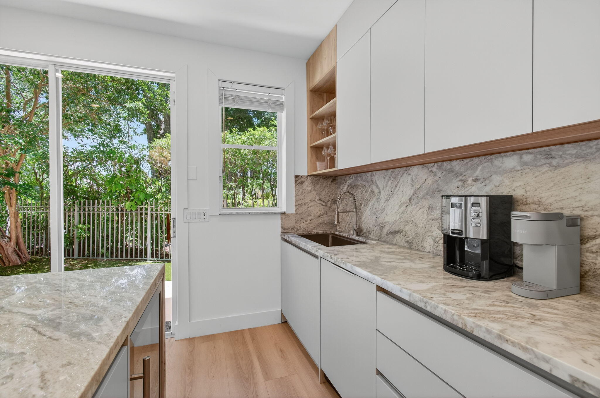2621 Northwest 53rd Drive Boca Raton, FL 33496 - Photo 16 of 52 a kitchen with a sink a counter top space and stainless steel appliances