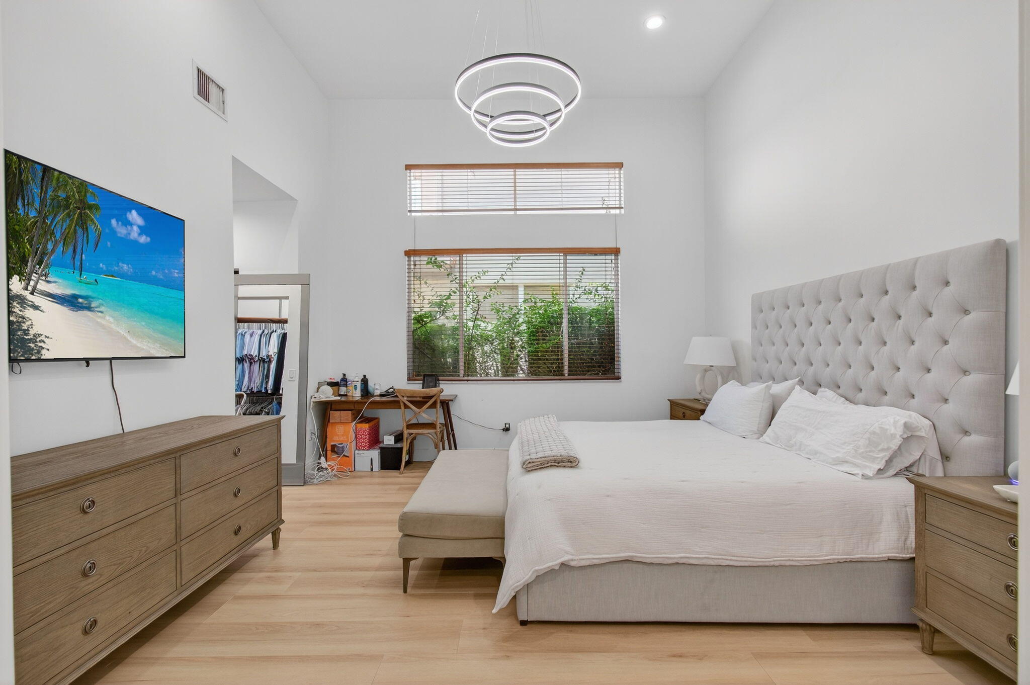 2621 Northwest 53rd Drive Boca Raton, FL 33496 - Photo 18 of 52 a bedroom with a large bed and a flat tv screen on dresser