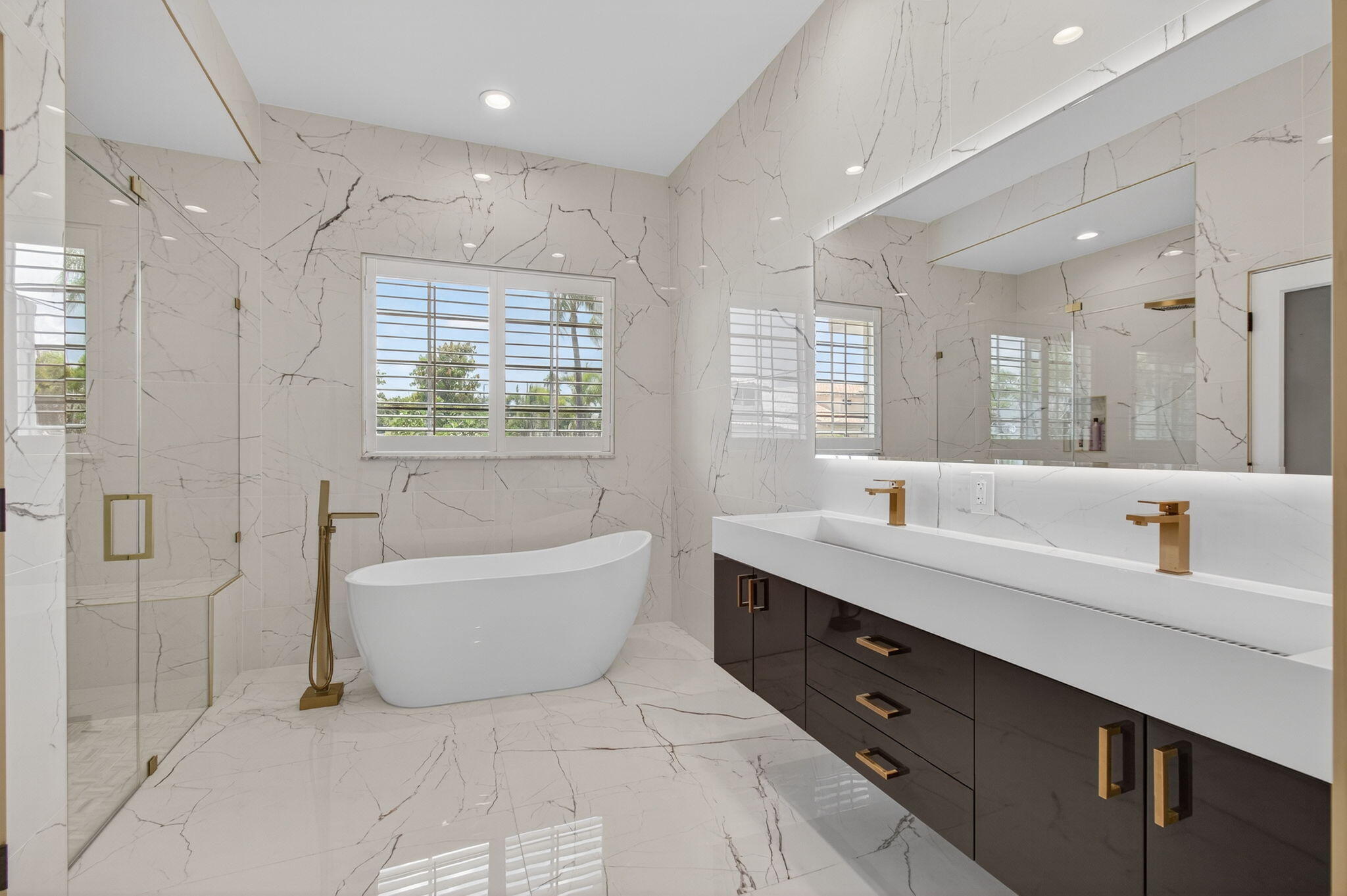 2621 Northwest 53rd Drive Boca Raton, FL 33496 - Photo 20 of 52 a bathroom with a tub a sink shower and mirror