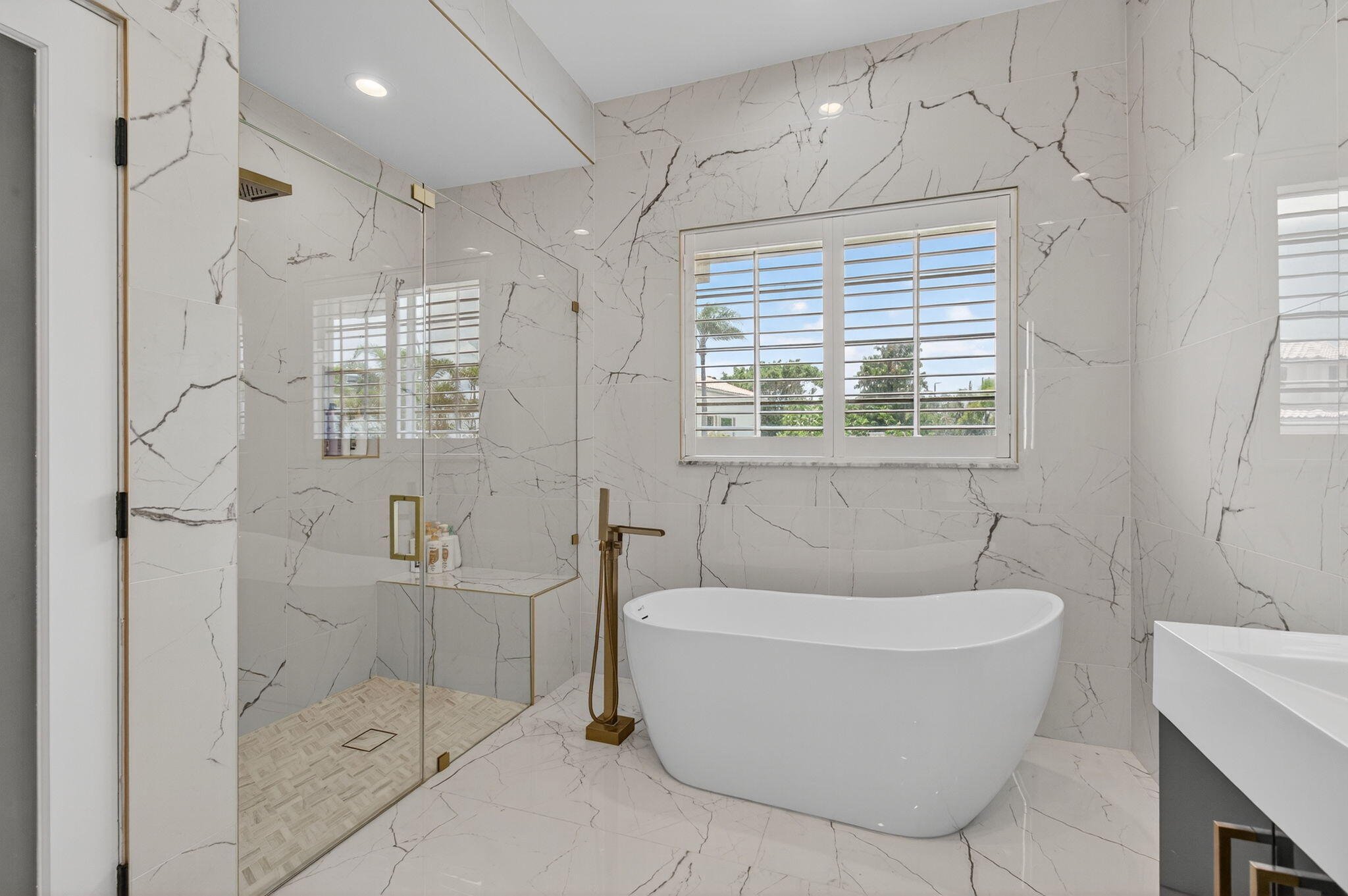 2621 Northwest 53rd Drive Boca Raton, FL 33496 - Photo 21 of 52 a white bath tub sitting next to a bathroom
