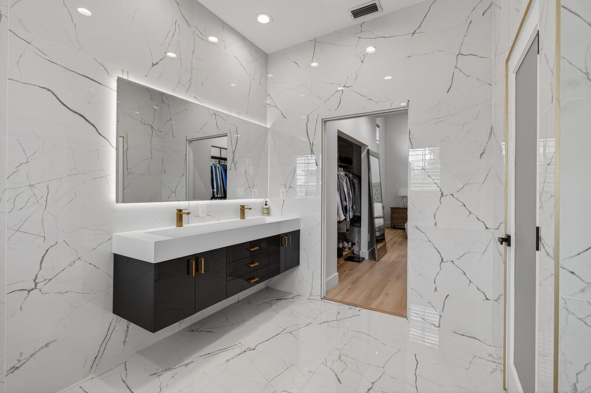 2621 Northwest 53rd Drive Boca Raton, FL 33496 - Photo 23 of 52 a spacious bathroom with a sink double vanity and a mirror