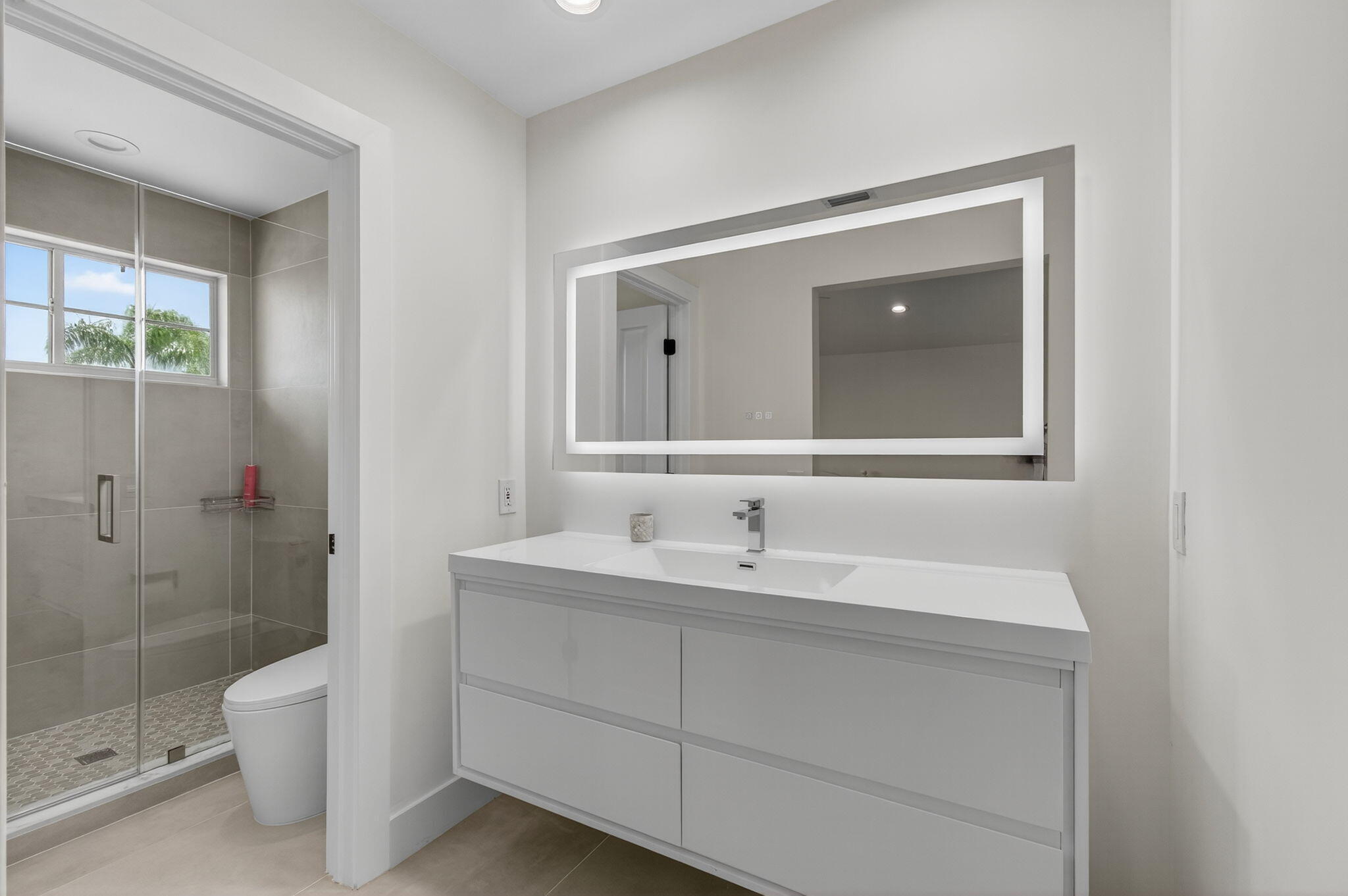 2621 Northwest 53rd Drive Boca Raton, FL 33496 - Photo 28 of 52 a bathroom with a toilet a sink and mirror