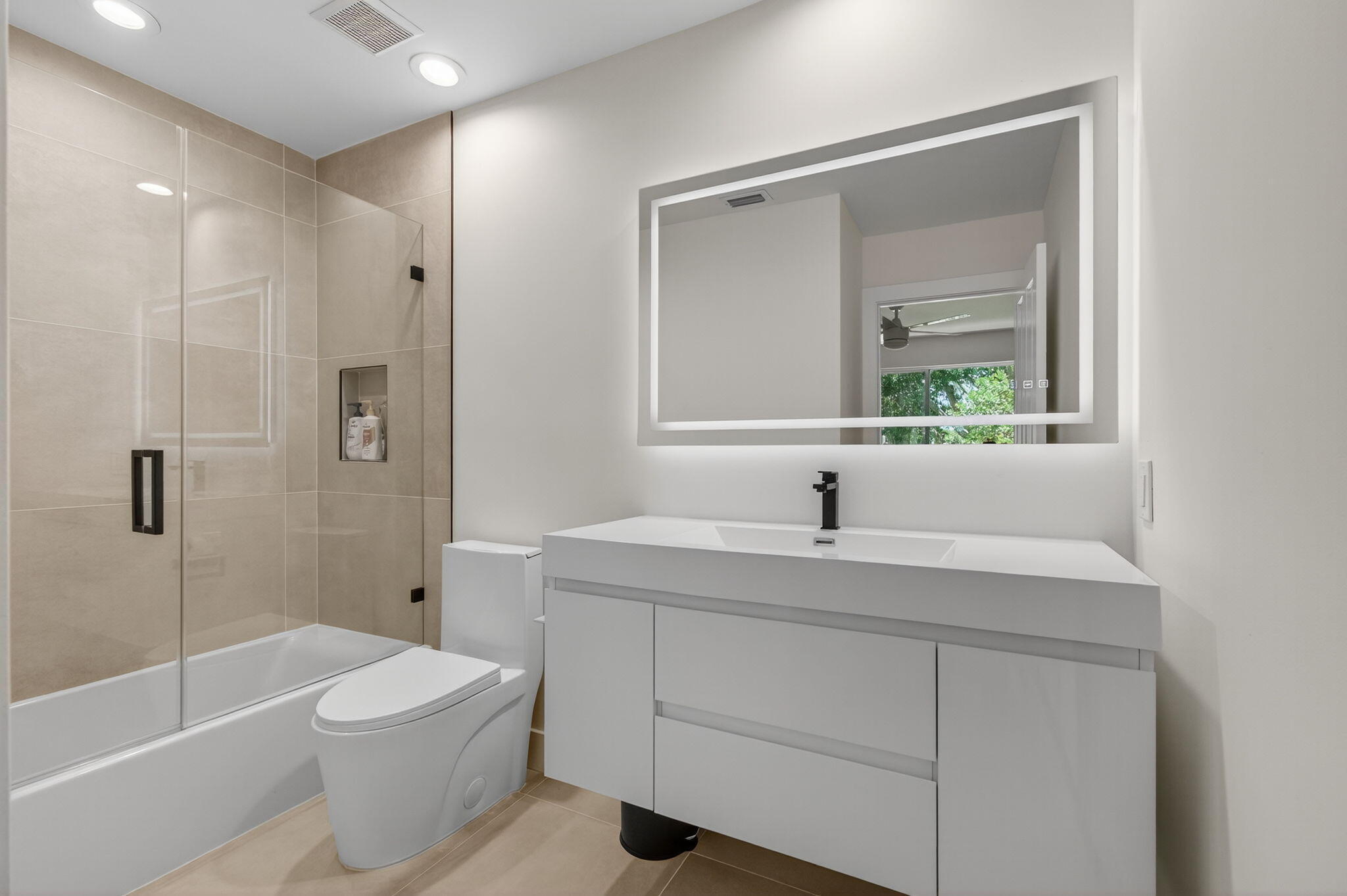 2621 Northwest 53rd Drive Boca Raton, FL 33496 - Photo 34 of 52 a bathroom with a granite countertop sink toilet a large mirror a vanity and shower