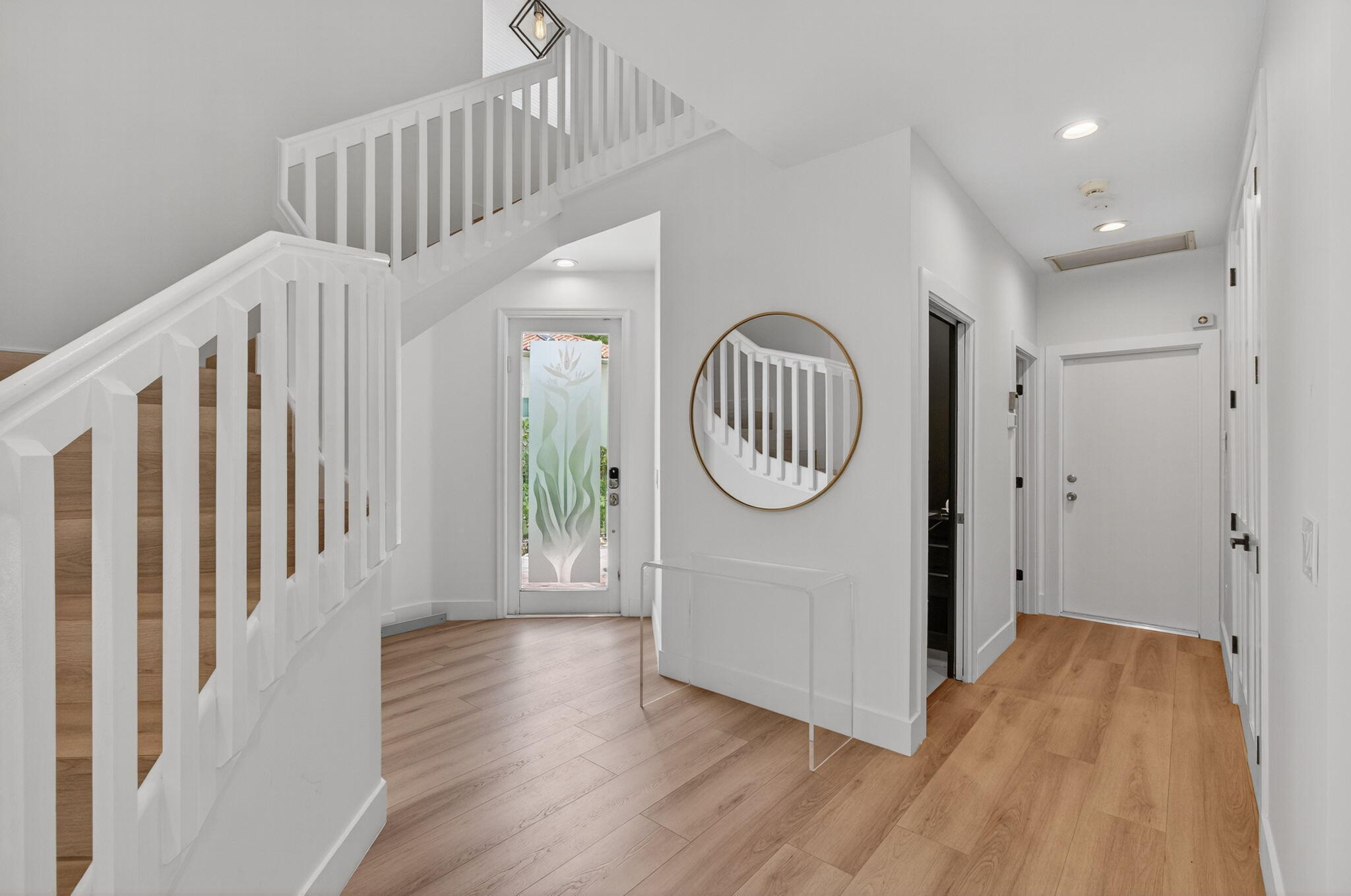 2621 Northwest 53rd Drive Boca Raton, FL 33496 - Photo 4 of 52 a view of a hallway with wooden floor and staircase