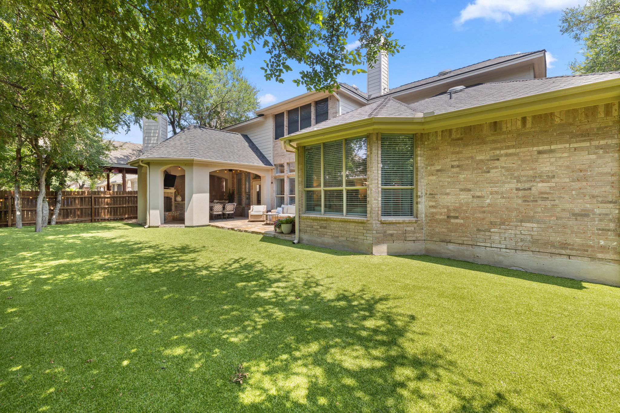 1124 Castle Path Round Rock, TX 78681 - Photo 38 of 40 A spacious yard with verdant artificial turf and a covered patio for outdoor entertaining.