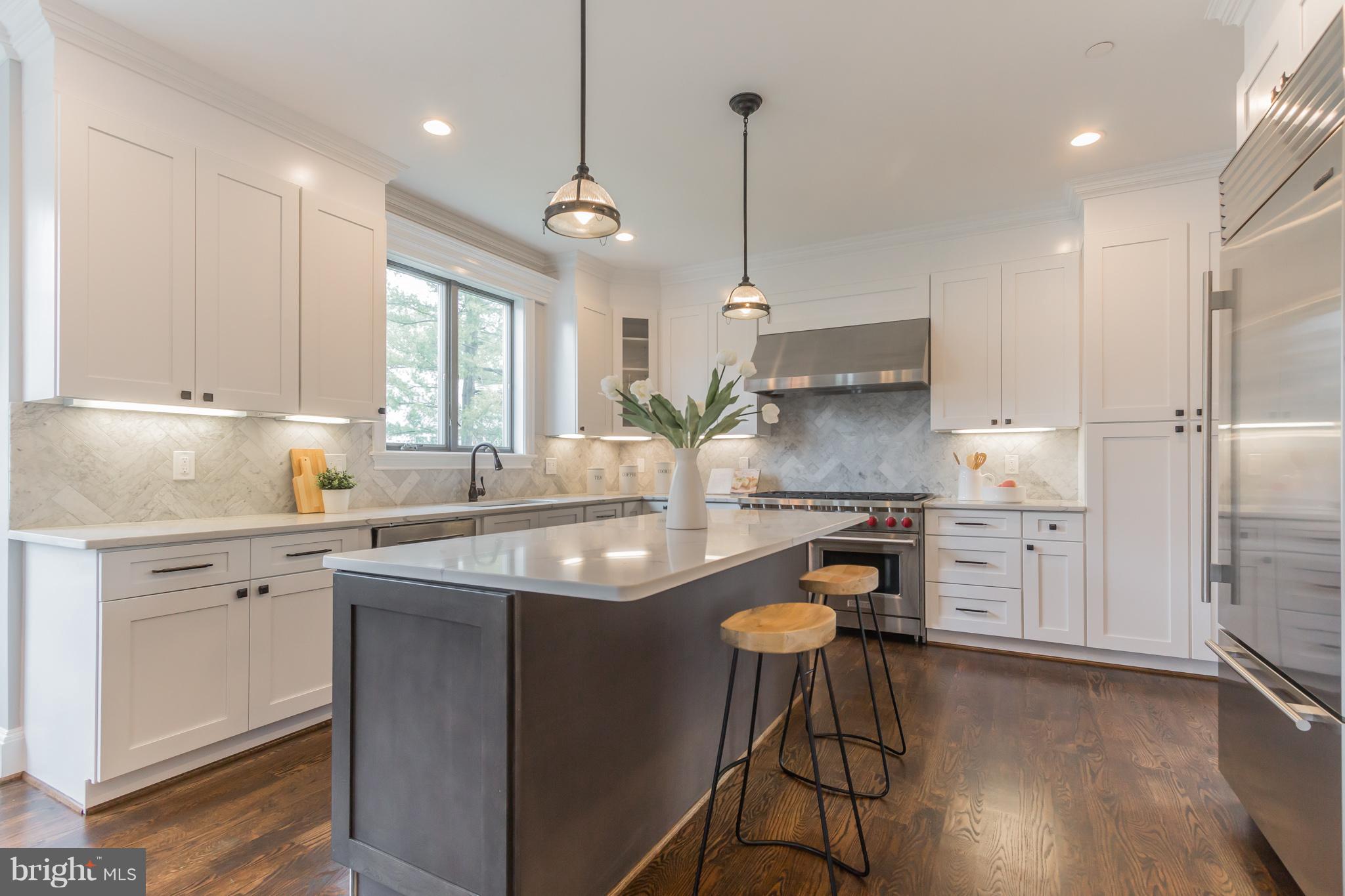 736 Thayer Avenue Silver Spring, MD 20910 - Photo 12 of 30 a kitchen with a refrigerator a sink and cabinets