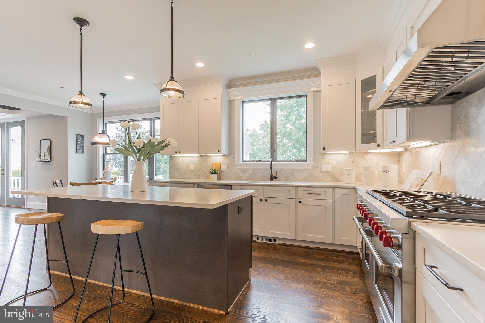 736 Thayer Avenue Silver Spring, MD 20910 - Photo 13 of 30 a kitchen with a stove a sink a window and chairs