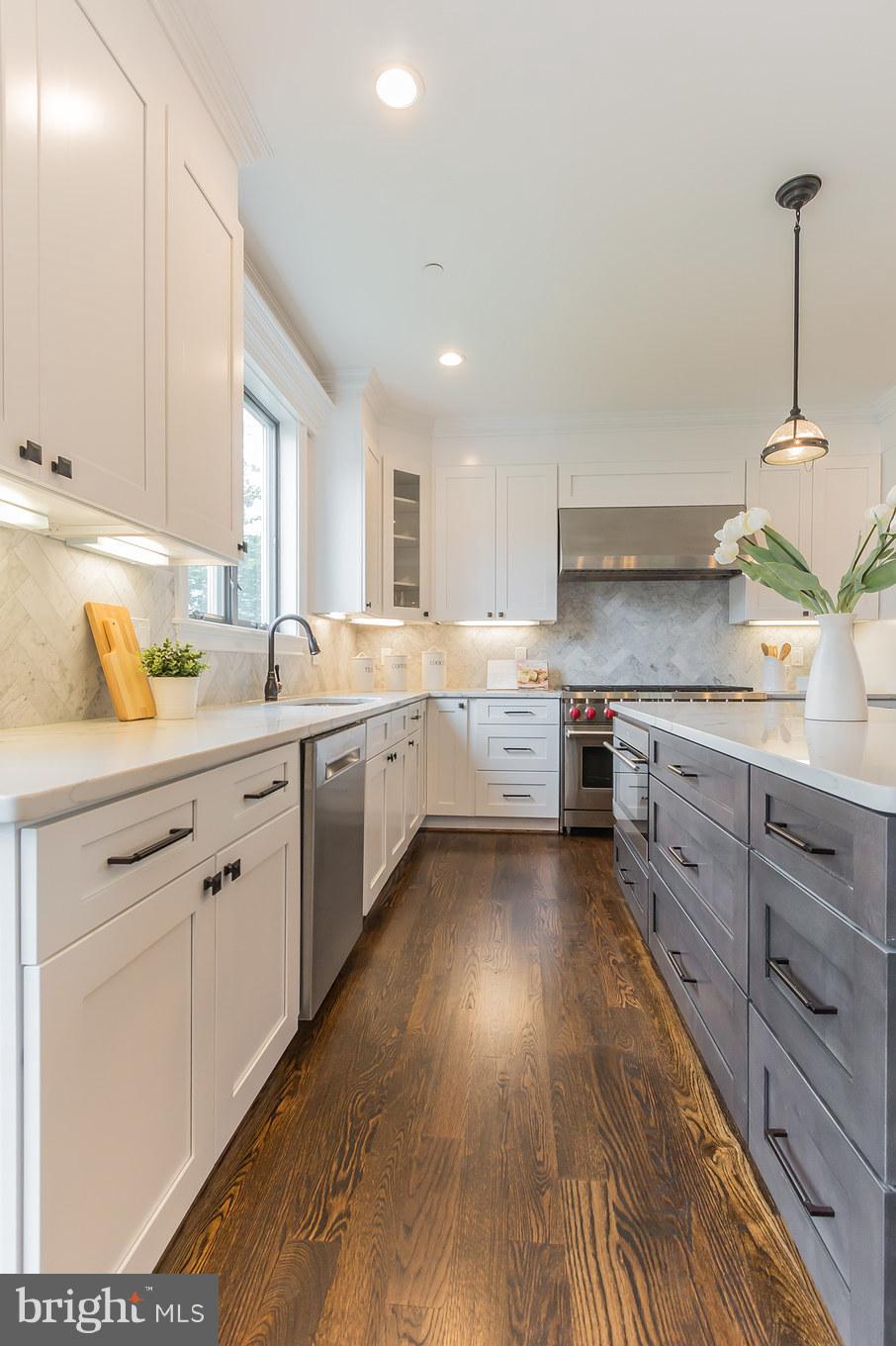 736 Thayer Avenue Silver Spring, MD 20910 - Photo 14 of 30 a kitchen with a sink window and cabinets