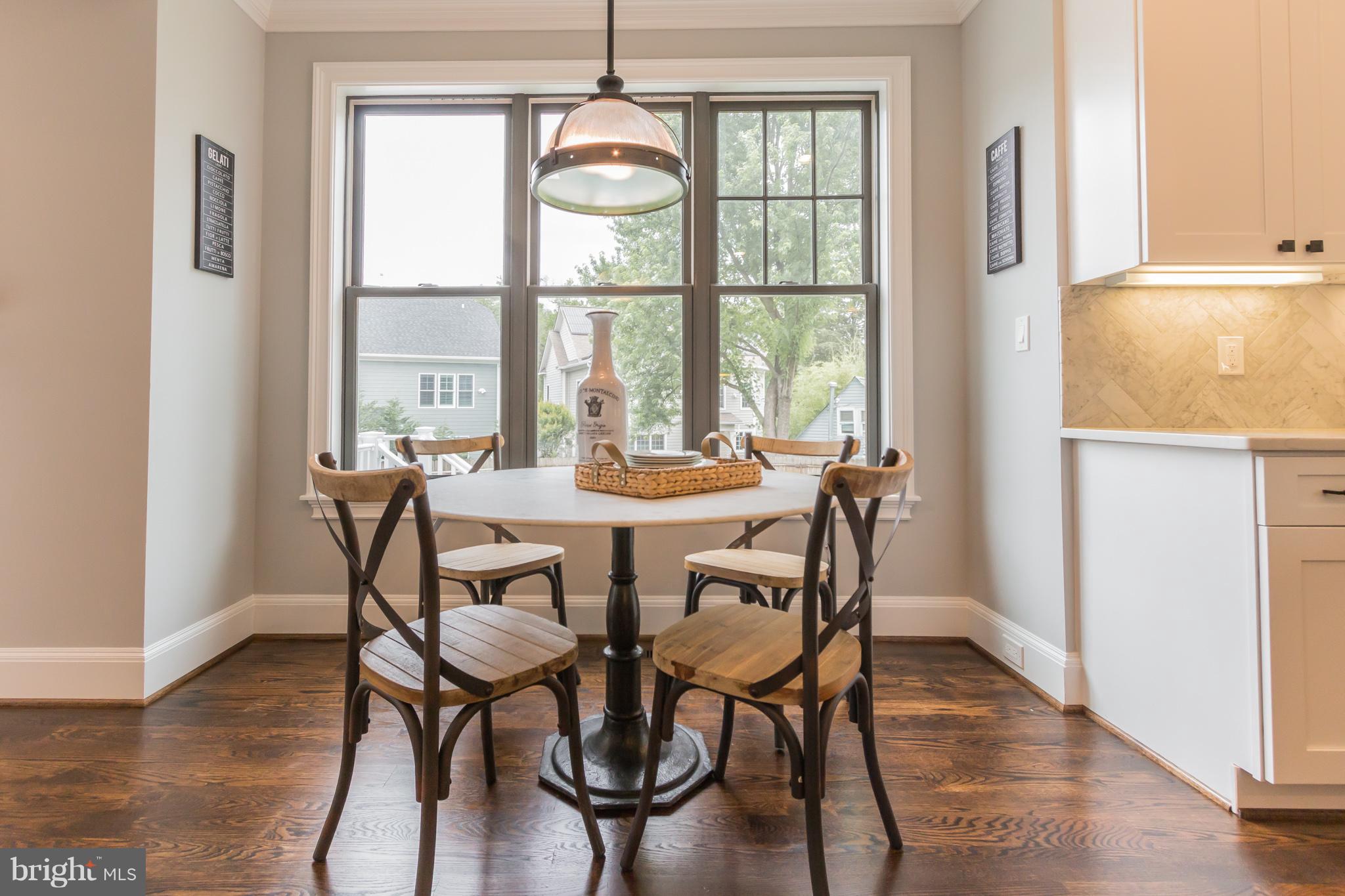 736 Thayer Avenue Silver Spring, MD 20910 - Photo 19 of 30 a dining room with furniture a chandelier and wooden floor