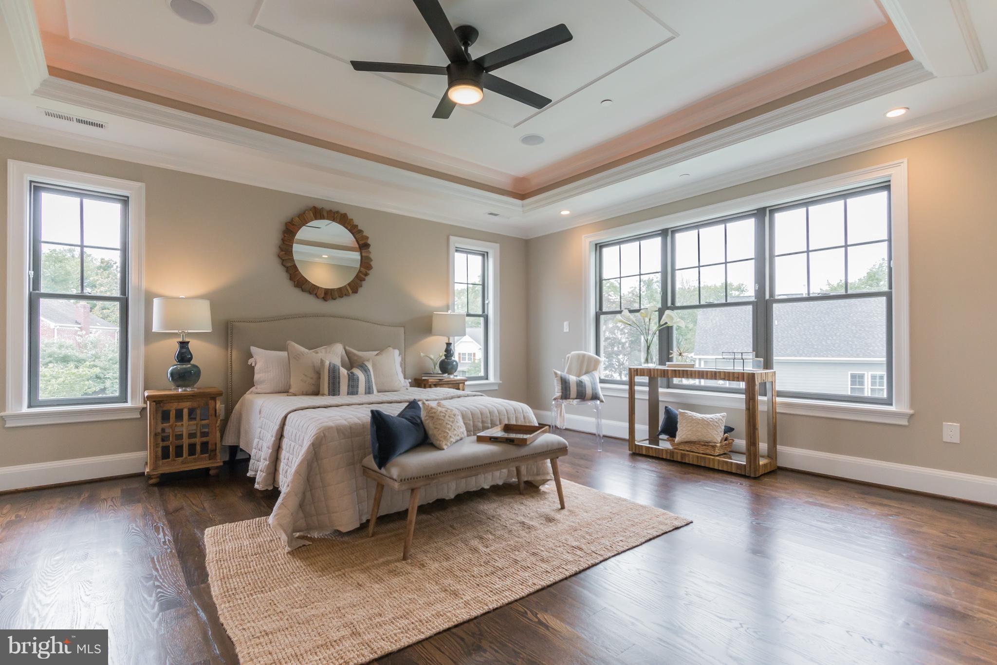 736 Thayer Avenue Silver Spring, MD 20910 - Photo 20 of 30 a bedroom with a bed wooden floor and windows