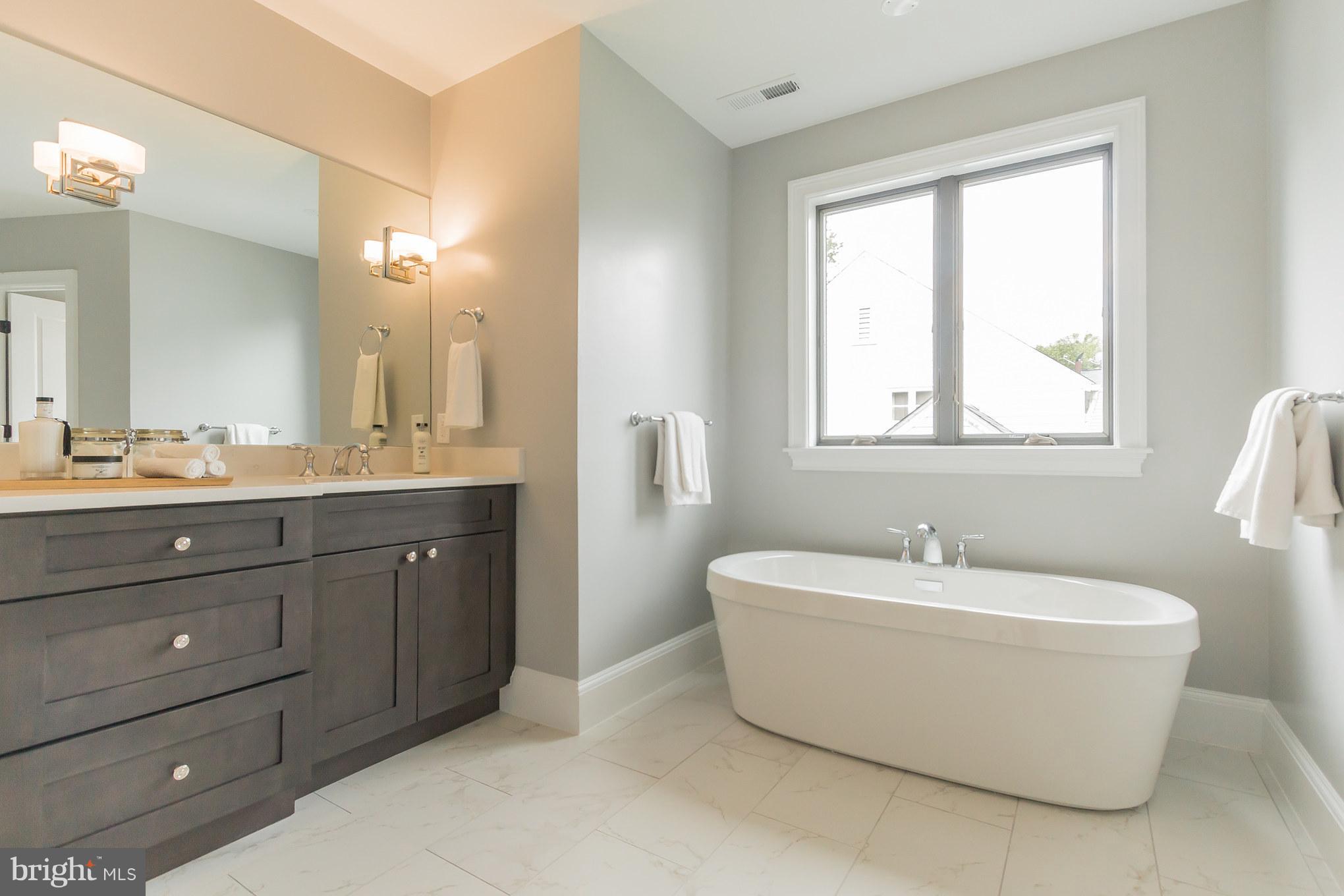 736 Thayer Avenue Silver Spring, MD 20910 - Photo 23 of 30 a spacious bathroom with a double vanity sink mirror and a bathtub
