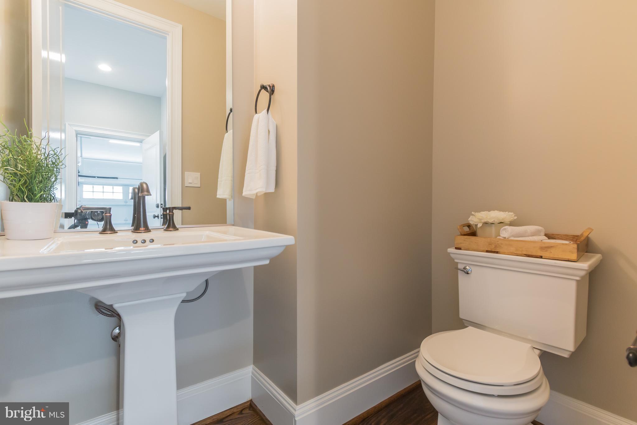 736 Thayer Avenue Silver Spring, MD 20910 - Photo 8 of 30 a bathroom with a sink toilet and mirror