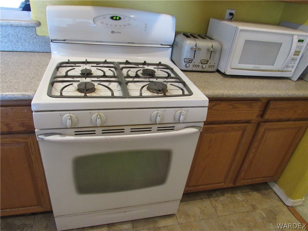 2002 Drake Road Golden Valley, AZ 86413 - Photo 10 of 50 a white stove top oven sitting inside of a kitchen