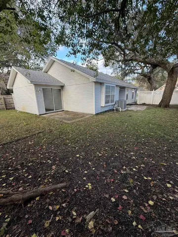 a house with green field in front of it