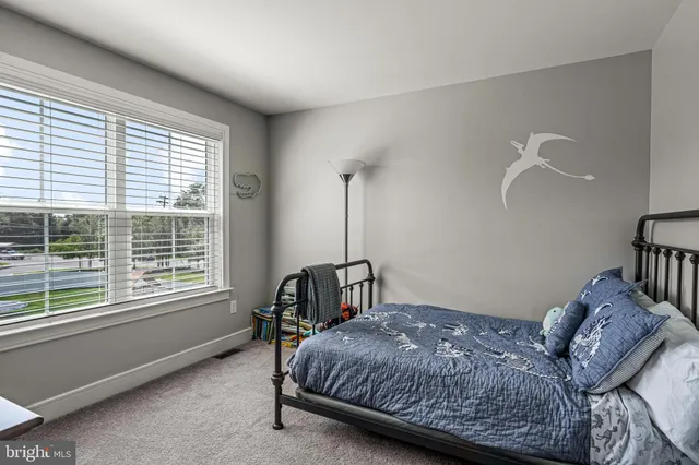 a bedroom with bed and a window